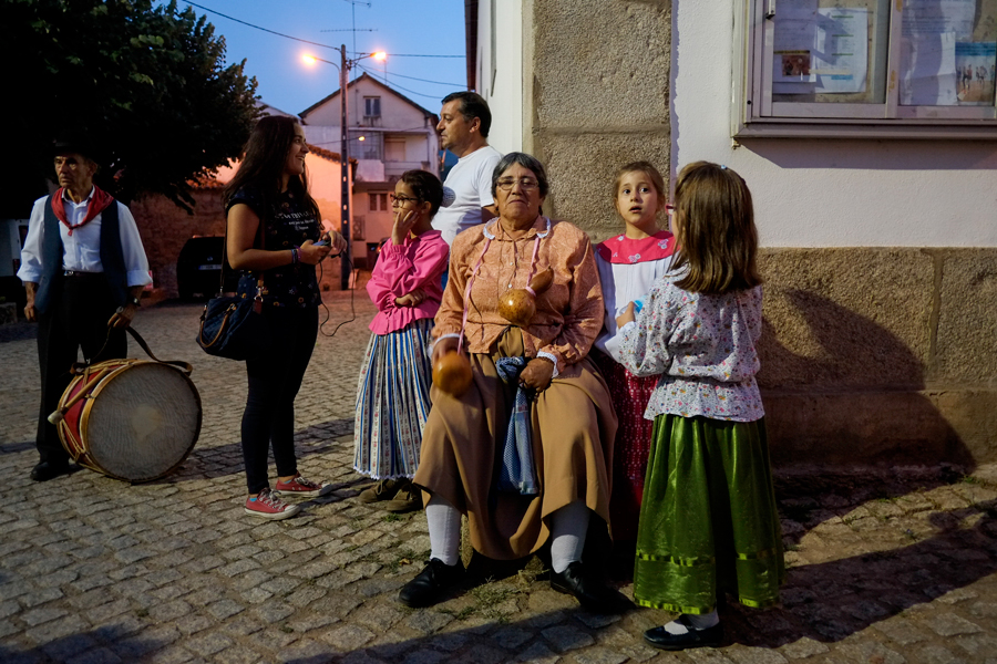 Dame assise à coté d'une église avec des enfants autour d'elle