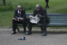 Deux hommes noirs assis sur un banc public