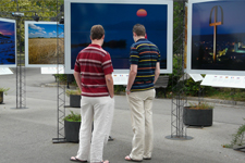 Deux hommes devant une photographie en exposition